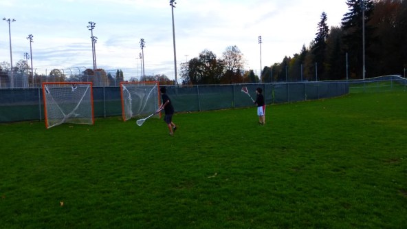 Boys Shooting Lacrosse Together